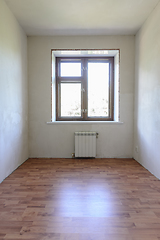 Image showing View of the window in a small room after renovation, wood-effect laminate is laid on the floor