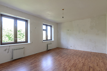 Image showing Interior of an empty room during renovation, there are two large windows in the room