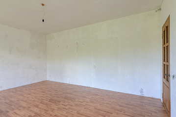 Image showing A fragment of the interior of a spacious room with a fine finish of the walls