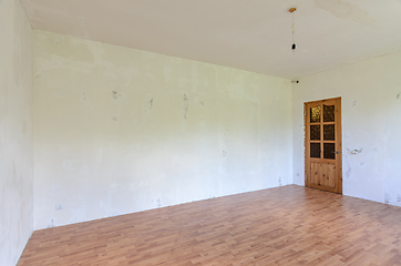 Image showing A fragment of the interior of a room with a fine finish, a view of the front door and an empty wall