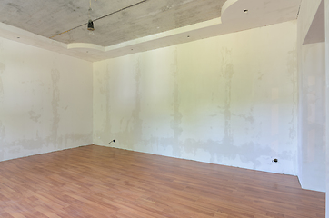 Image showing Interior of an empty room after renovation, gray walls, laminate flooring on the floor