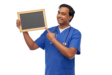 Image showing happy indian male doctor or nurse with chalkboard