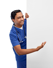 Image showing smiling male doctor or nurse with big white board