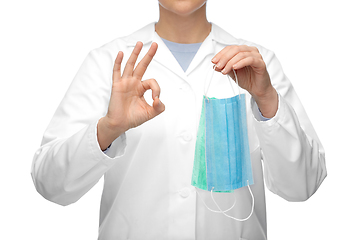 Image showing female doctor with medical mask showing ok gesture