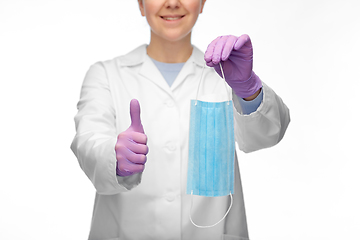 Image showing female doctor with medical mask showing thumbs up