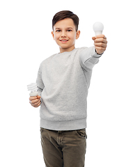 Image showing smiling boy comparing different light bulbs