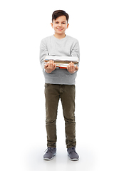 Image showing smiling boy with magazines sorting paper waste