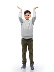 Image showing happy smiling boy holding something imaginary