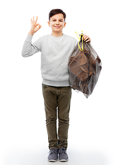 Image showing smiling boy with paper garbage in plastic bag