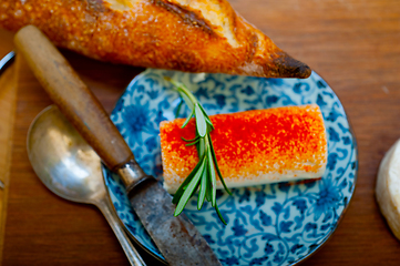 Image showing French cheese and fresh  baguette on a wood cutter