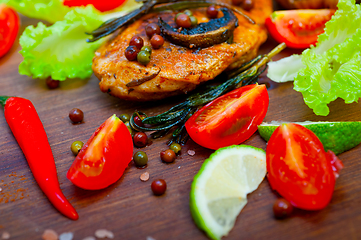 Image showing wood fired hoven cooked chicken breast on wood board