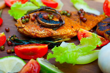 Image showing wood fired hoven cooked chicken breast on wood board