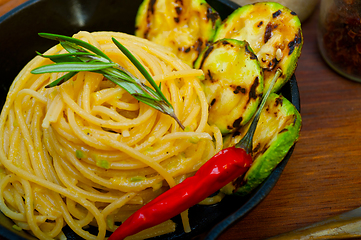 Image showing italian spaghetti pasta with zucchini sauce on iron skillet