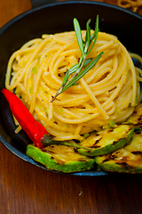 Image showing italian spaghetti pasta with zucchini sauce on iron skillet