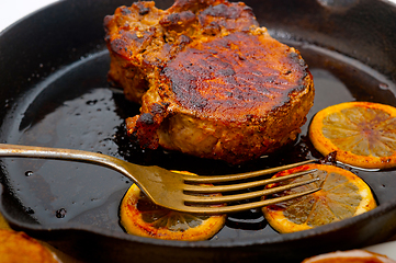 Image showing pork chop seared on iron skillet