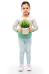 Image showing happy smiling girl holding flower in pot