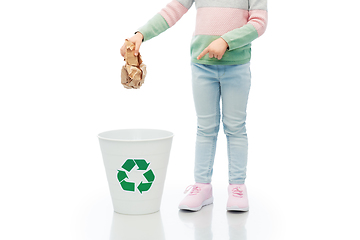 Image showing girl throwing paper waste into rubbish bin