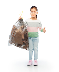 Image showing smiling girl with paper garbage in plastic bag