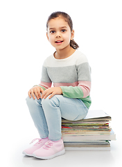 Image showing smiling girl with magazines sorting paper waste