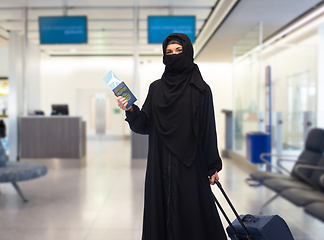 Image showing muslim woman with ticket, immune passport and bag