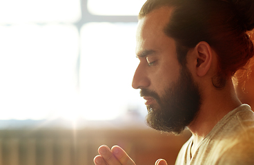 Image showing close up of man meditating at yoga studio