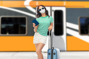 Image showing teenage girl in mask with travel bag and passport