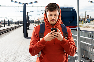 Image showing man with smartphone traveling by train