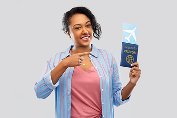 Image showing happy woman with air ticket and immunity passport