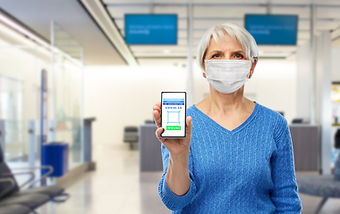 Image showing old woman with certificate of vaccination on phone