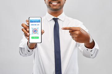 Image showing man with certificate of vaccination on smartphone