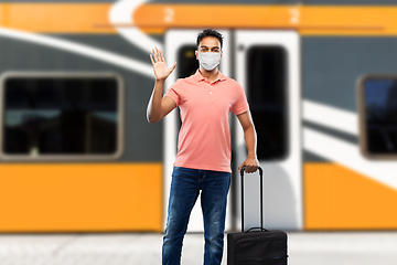 Image showing indian man in mask with travel bag waving hand