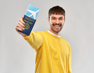 Image showing smiling man with air ticket and immunity passport
