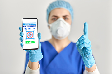 Image showing doctor with immunity passport on smartphone screen