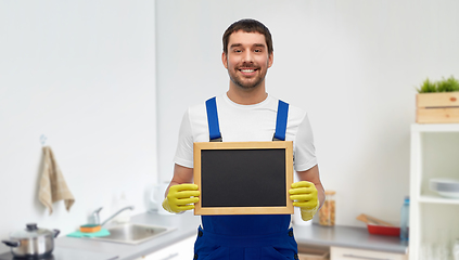 Image showing male cleaner with chalkboard at at kitchen