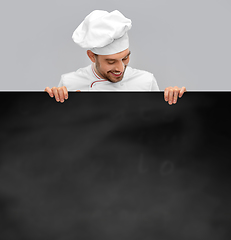 Image showing happy smiling male chef with big black chalkboard