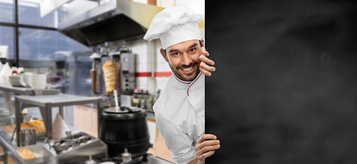 Image showing happy smiling male chef with big black chalkboard