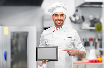 Image showing male chef showing tablet pc at restaurant kitchen