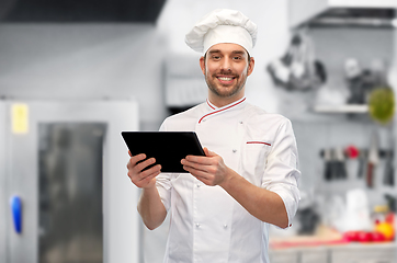 Image showing male chef with tablet pc at restaurant kitchen