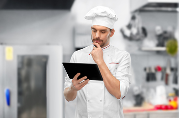 Image showing male chef with tablet pc at restaurant kitchen