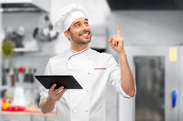 Image showing male chef with tablet computer pointing finger up