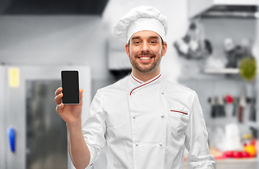 Image showing happy smiling male chef showing smartphone