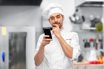 Image showing male chef with smartphone at restaurant kitchen