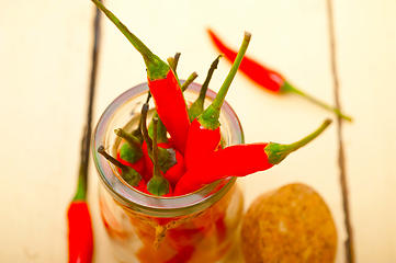 Image showing red chili peppers on a glass jar