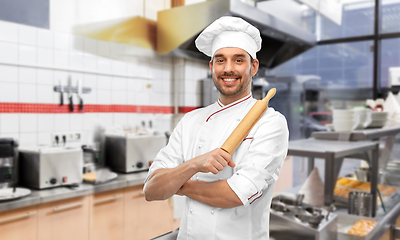 Image showing happy male chef with rolling pin at kitchen