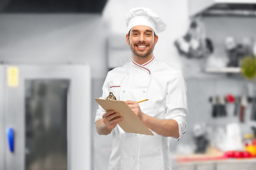 Image showing happy smiling male chef with clipboard and pencil