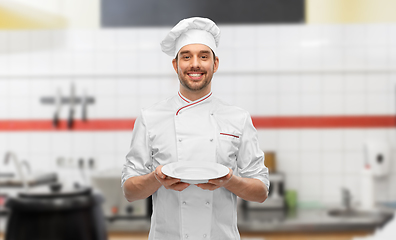 Image showing happy smiling male chef holding empty plate