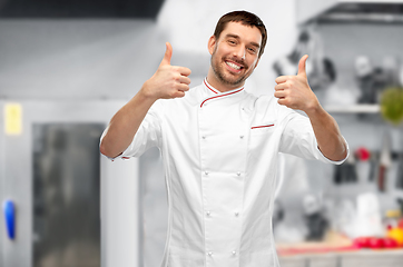 Image showing smiling male chef in jacket showing thumbs up