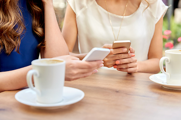 Image showing close up of women with smartphone at street cafe