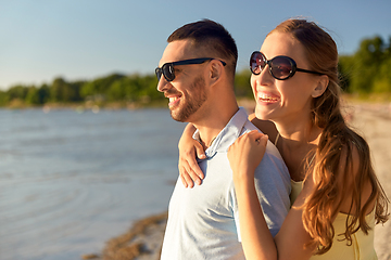 Image showing happy couple hugging on summer beach