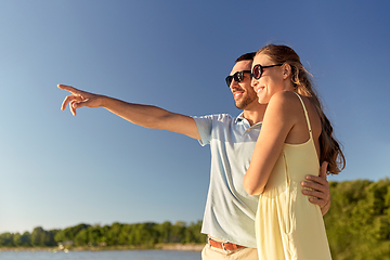 Image showing happy couple hugging on summer beach